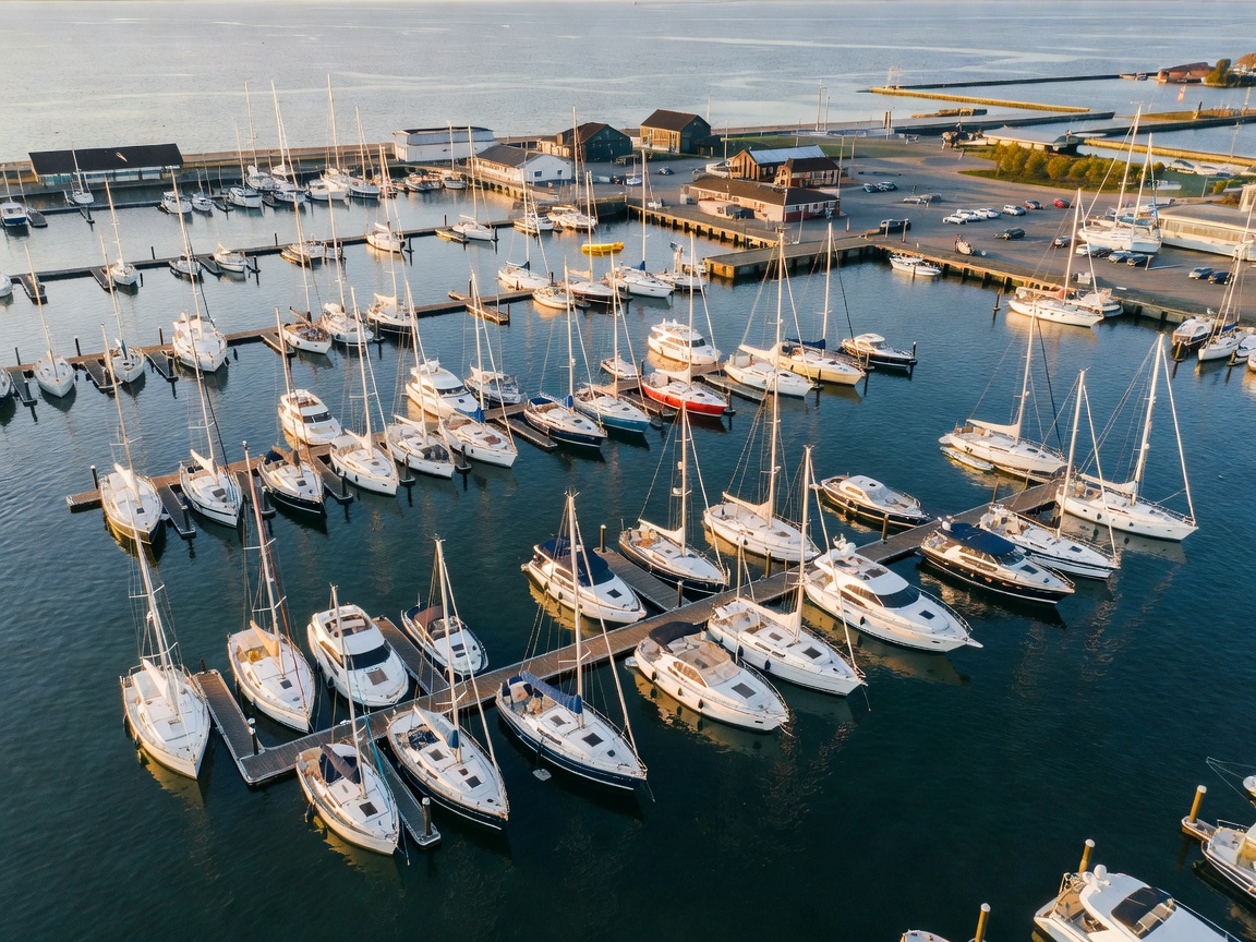 Aerial view of a large marina in Kiel showing numerous sailing and motor yachts floating realistically in harbor water